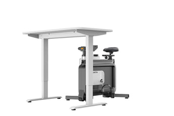 Ingeklapte WalkingPad W1B Office Bike vrijstaand bij een tafel