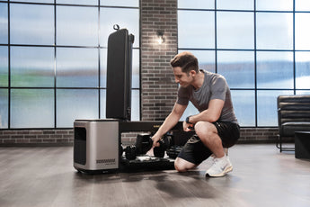 kingsmith-bx2-fitnessbank-adjustable-dumbbells-instellen — Man stelt adjustable dumbbells in bij Kingsmith BX2