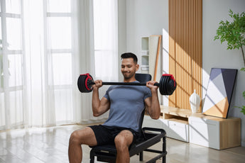 Kingsmith Adjustable Dumbbells in de woonkamer met een man zittend op een bank